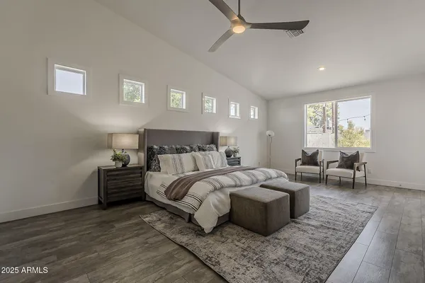an aerial view of a house with swimming pool and mountains