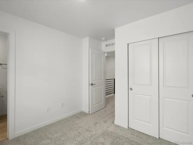 an empty room with closet area