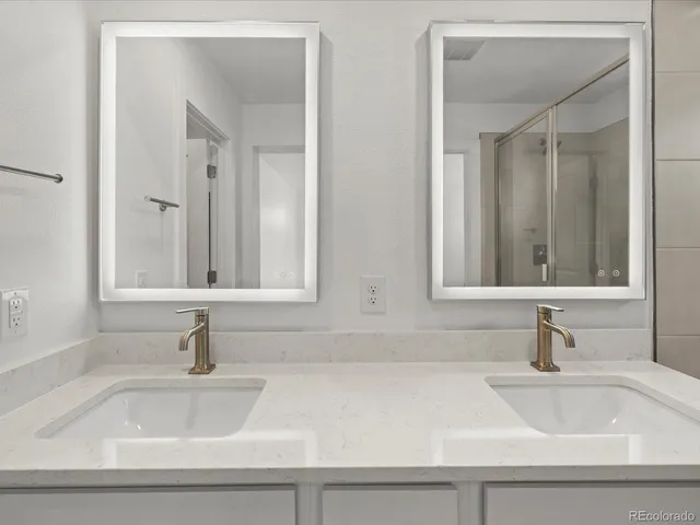 a bathroom with double sink and a mirror
