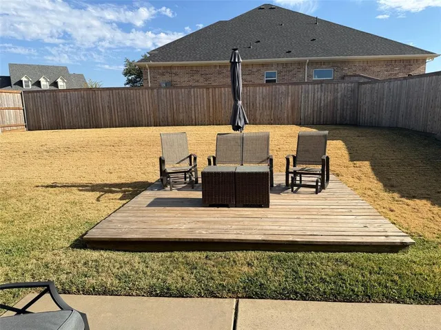 a view of a patio with chairs and a table