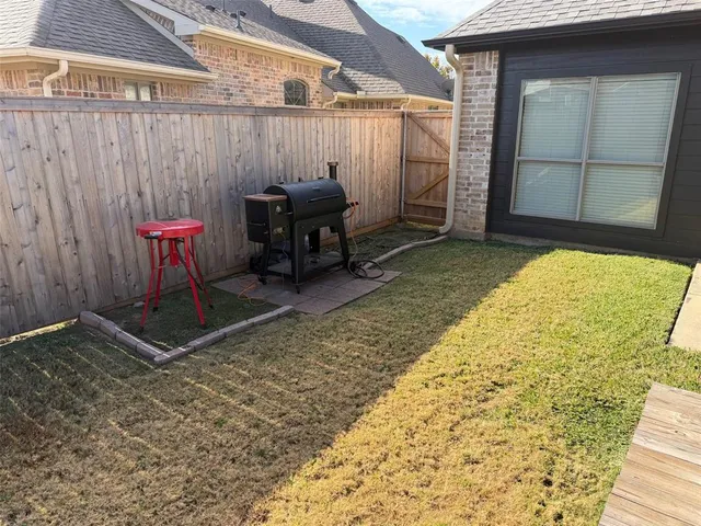 a backyard of a house with table and chairs