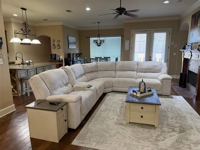 a living room with furniture and a chandelier