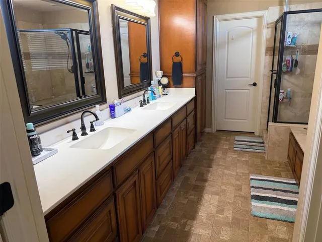 a bathroom with a double vanity sink a and mirror