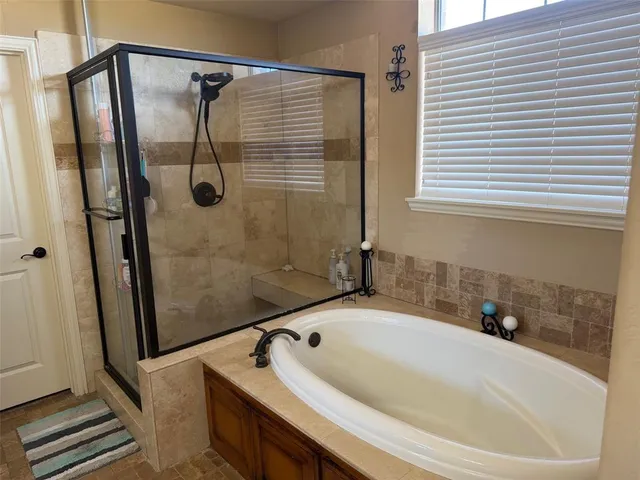 a bath tub sitting next to a shower