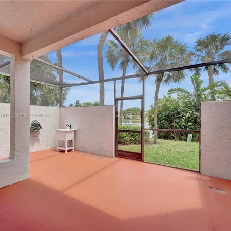 a view of an outdoor kitchen and a porch