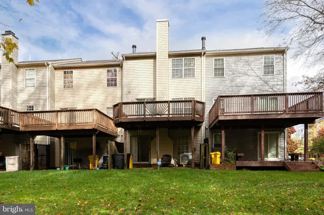 a front view of a brick building with a yard