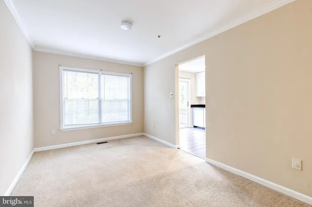 an empty room with a window and a bathroom