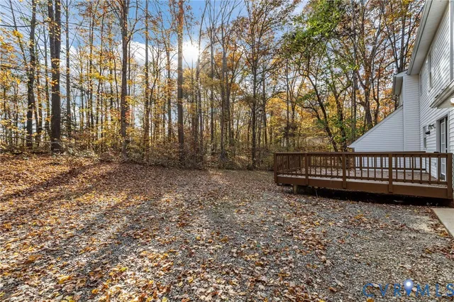 a view of a yard with wooden fence