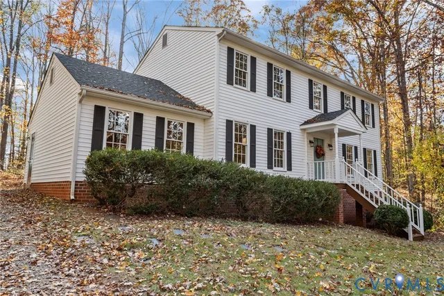 a view of a brick house with large windows