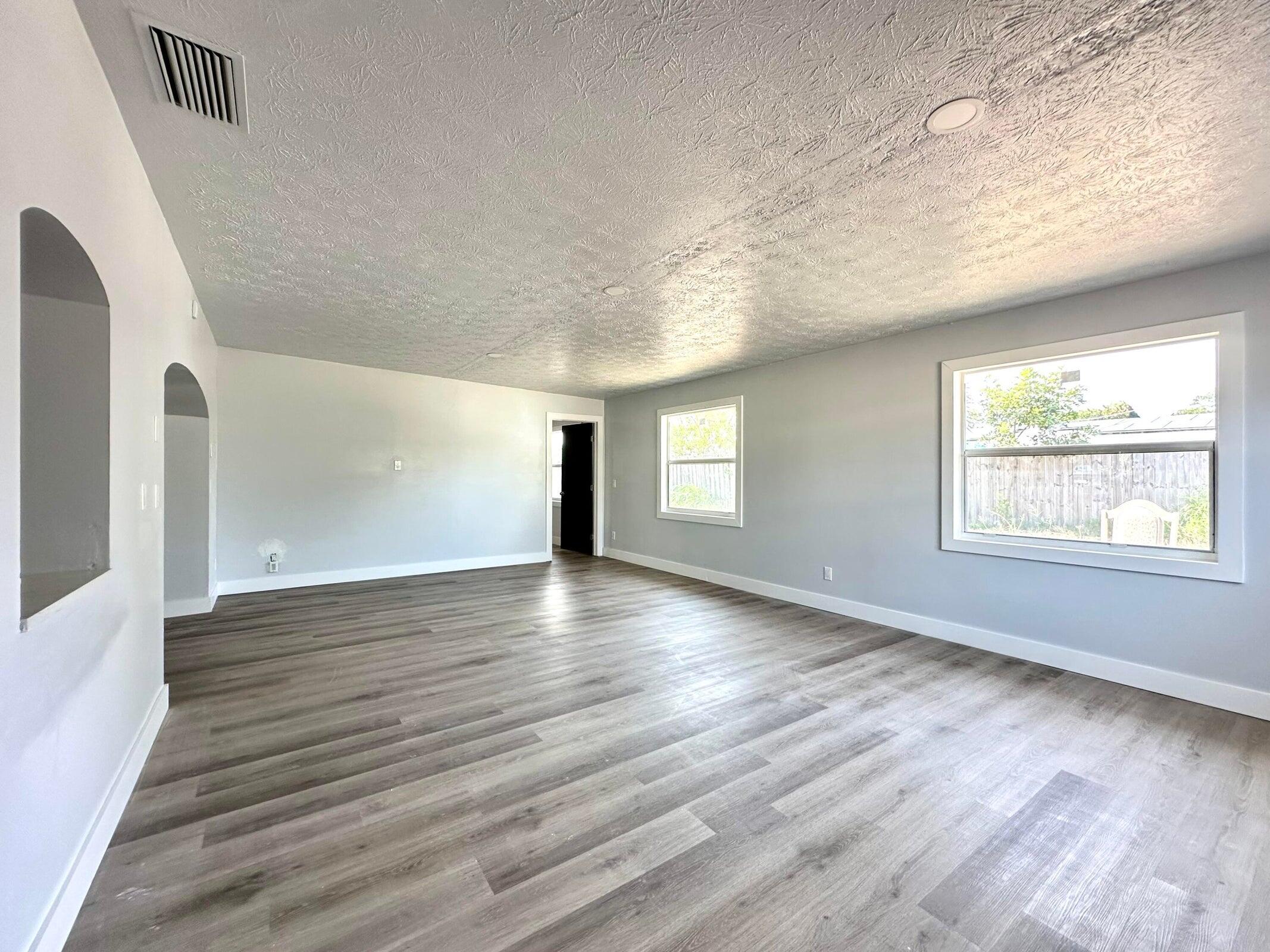 1455 Northeast Silver Maple Way Jensen Beach, FL 34957 - Photo 24 of 55 a view of an empty room with wooden floor and a window