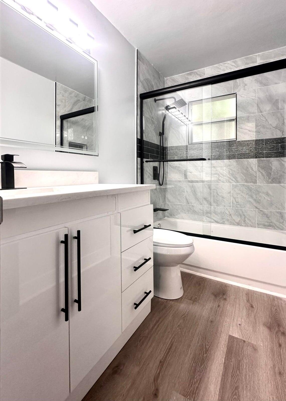 1455 Northeast Silver Maple Way Jensen Beach, FL 34957 - Photo 34 of 55 a bathroom with a sink a toilet and shower