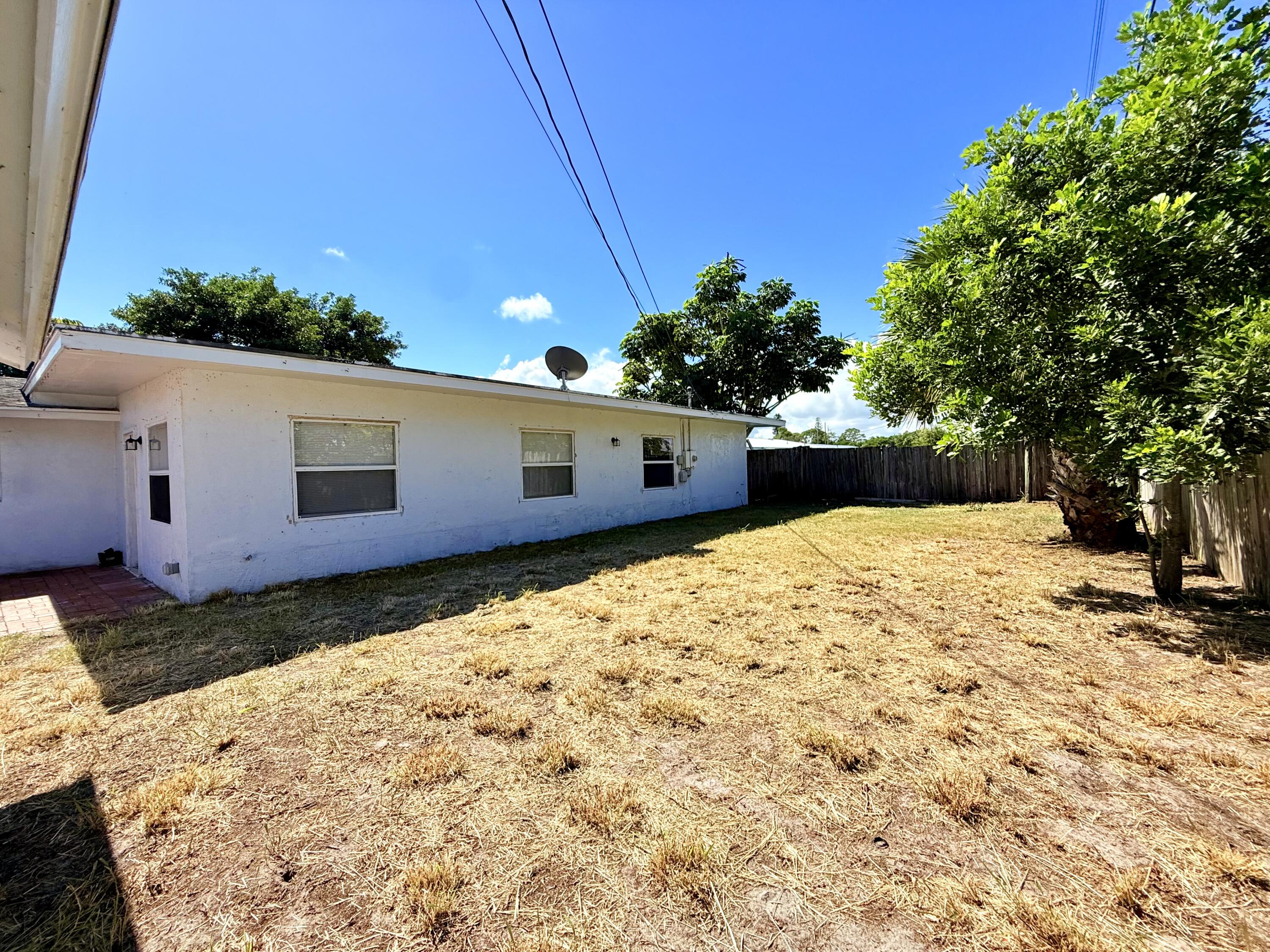 1455 Northeast Silver Maple Way Jensen Beach, FL 34957 - Photo 41 of 55 a view of a backyard of the house