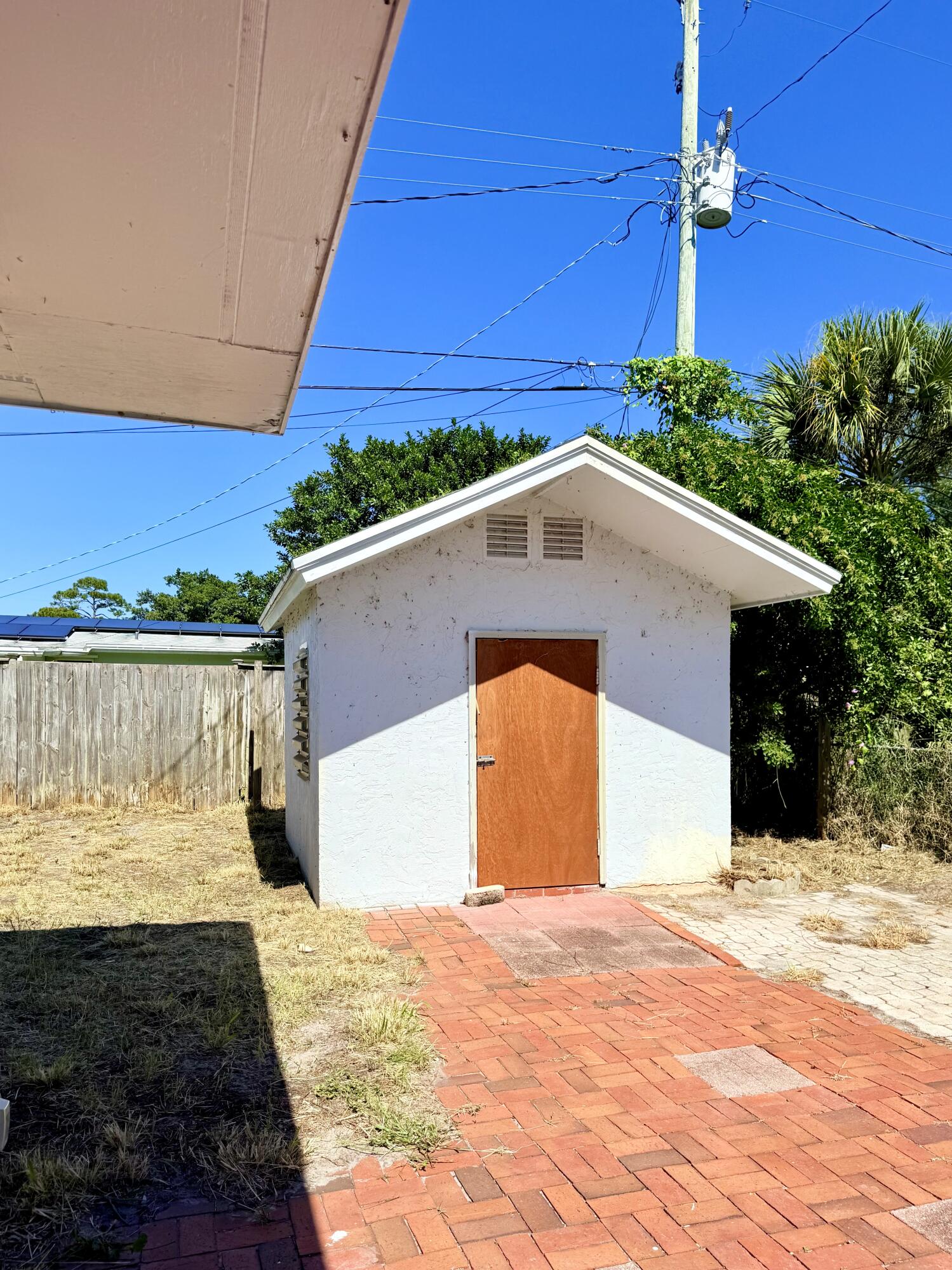 1455 Northeast Silver Maple Way Jensen Beach, FL 34957 - Photo 48 of 55 a front view of a house with a yard