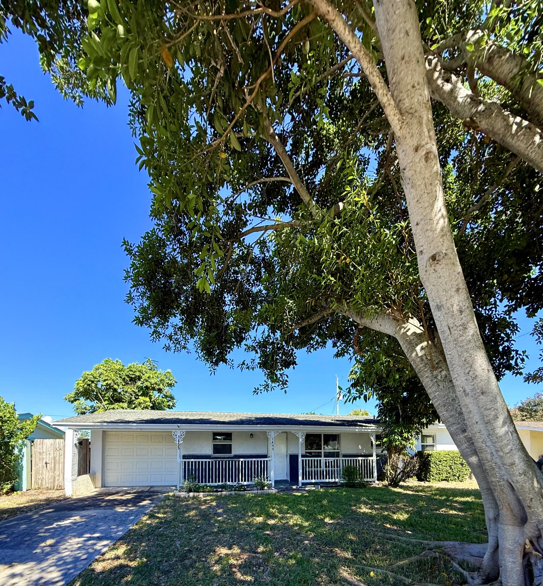 1455 Northeast Silver Maple Way Jensen Beach, FL 34957 - Photo 5 of 55 a front view of a house with garden