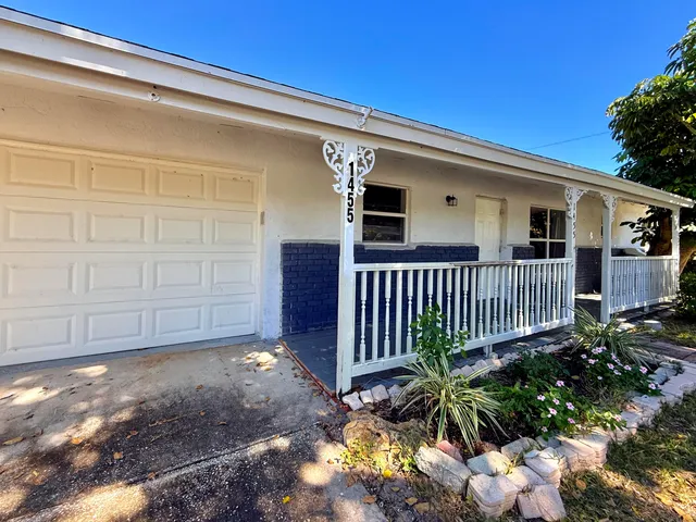 a kitchen with granite countertop a refrigerator stove and microwave