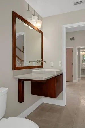 a spacious bathroom with a tub a double vanity sink a window and a shower