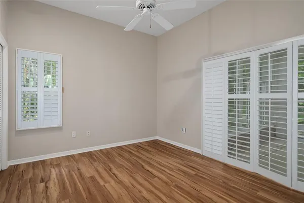 a view of walk in closet with wooden floor