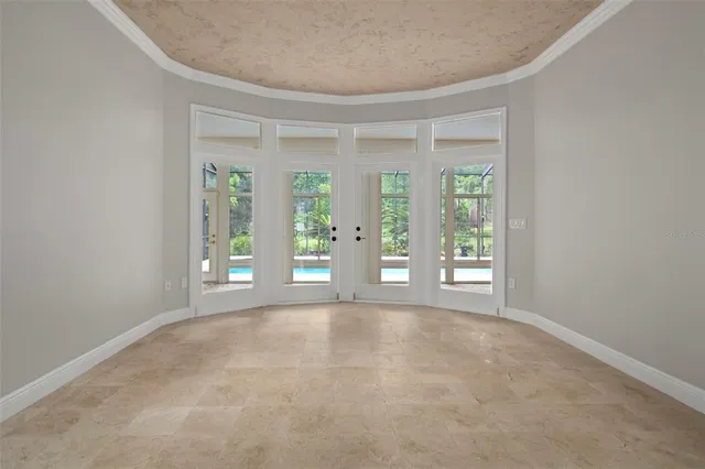 a view of a kitchen with wooden floor and a ceiling fan