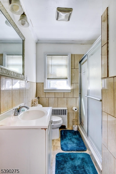 910 Wootton Street Boonton, NJ 07005 - Photo 13 of 21 a bathroom with a sink a toilet and a mirror