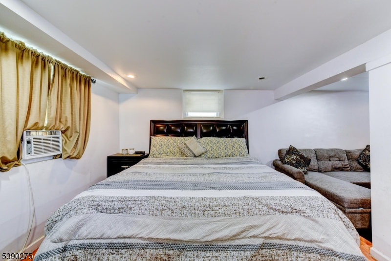 910 Wootton Street Boonton, NJ 07005 - Photo 16 of 21 a large bed sitting in a bedroom next to a window