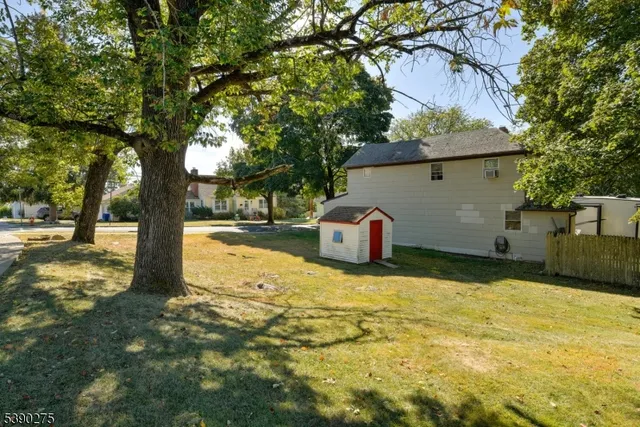 a backyard of a house with table and chairs