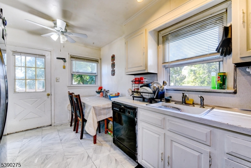 910 Wootton Street Boonton, NJ 07005 - Photo 8 of 21 a kitchen with sink cabinets and window