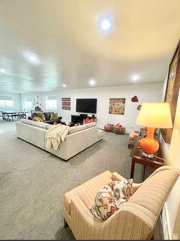 838 East Mountain Road North Ogden, UT 84414 - Photo 28 of 37 Spacious entertainment room featuring recessed lighting, light-toned carpeting, and multiple windows