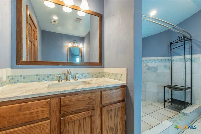 a bathroom with a sink and a mirror