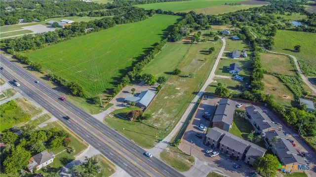 an aerial view of a residential houses with outdoor space