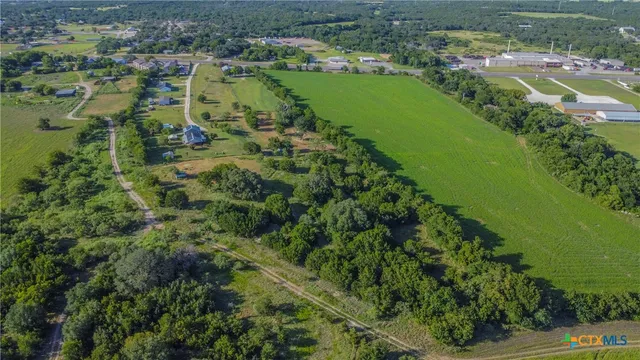 an aerial view of residential houses with outdoor space and river