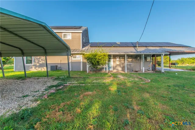 a view of a house with a backyard