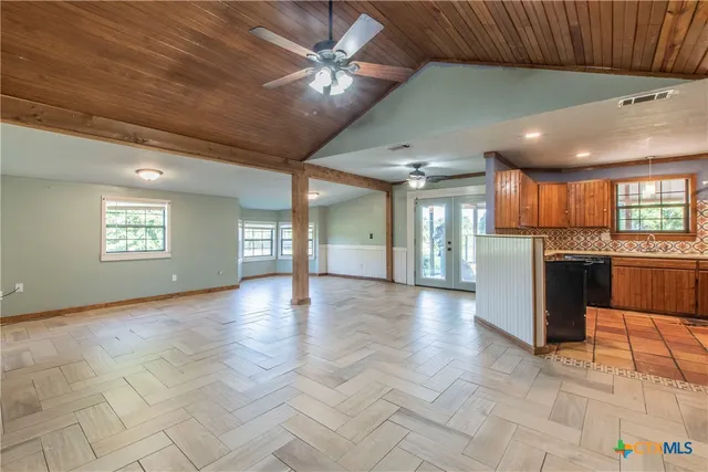 a view of an empty room with a kitchen
