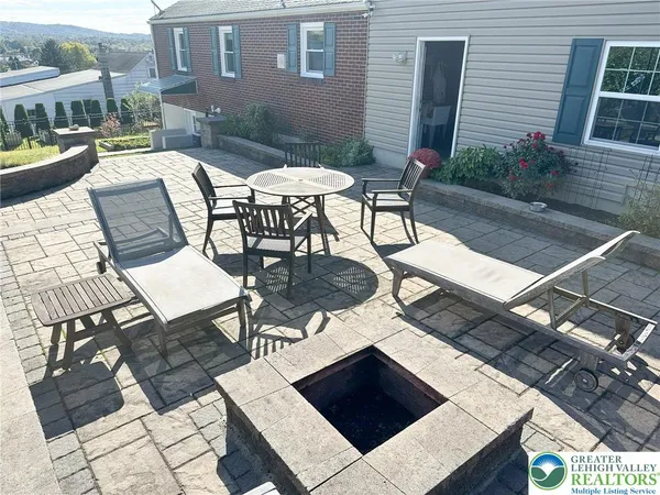 a view of a house with backyard and sitting area