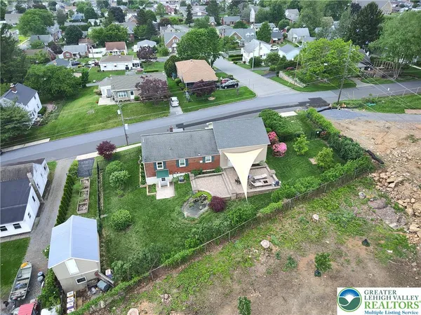 an aerial view of a house with garden space and street view