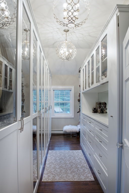 3 Brewer Way Hingham, MA 02043 - Photo 15 of 36 a room with fireplace cabinets and a chandelier