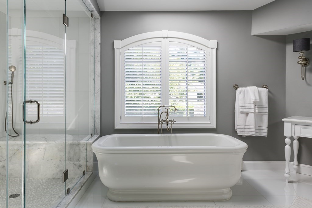 3 Brewer Way Hingham, MA 02043 - Photo 16 of 36 a bath tub sitting in a bathroom next to a window