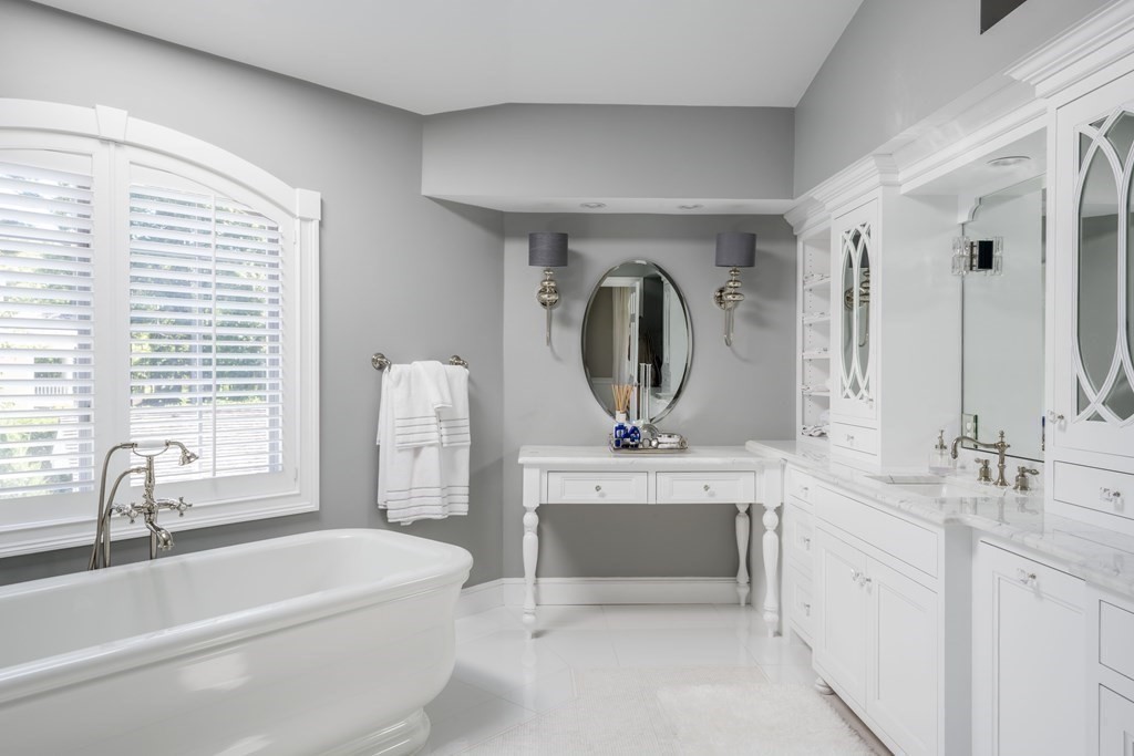 3 Brewer Way Hingham, MA 02043 - Photo 18 of 36 a bathroom with a double vanity sink a mirror and bathtub