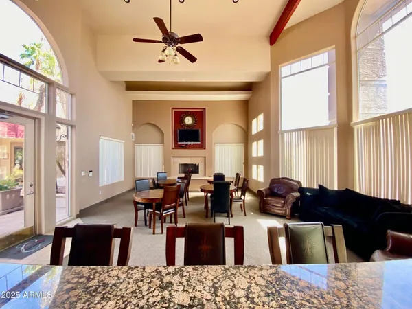 a living room with furniture large window and wooden floor
