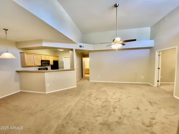 a view of a kitchen with a sink and a chandelier