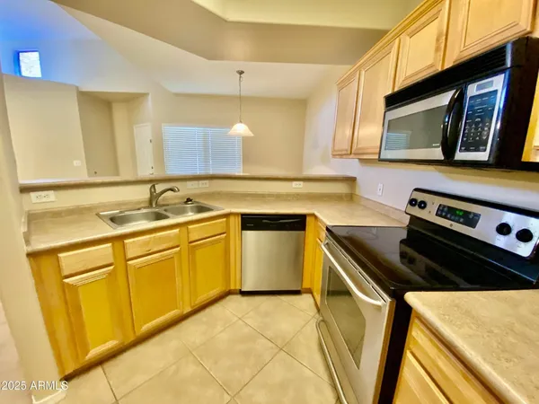 a kitchen with stainless steel appliances cabinets a sink and a stove