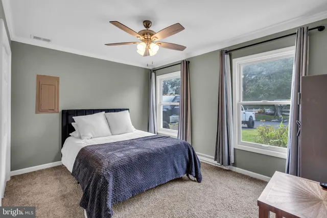 a bedroom with a large bed and a window