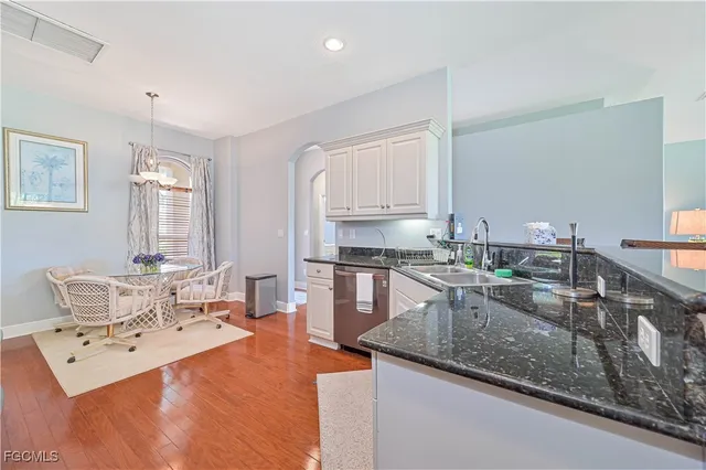 a kitchen with stainless steel appliances granite countertop a sink stove and cabinets
