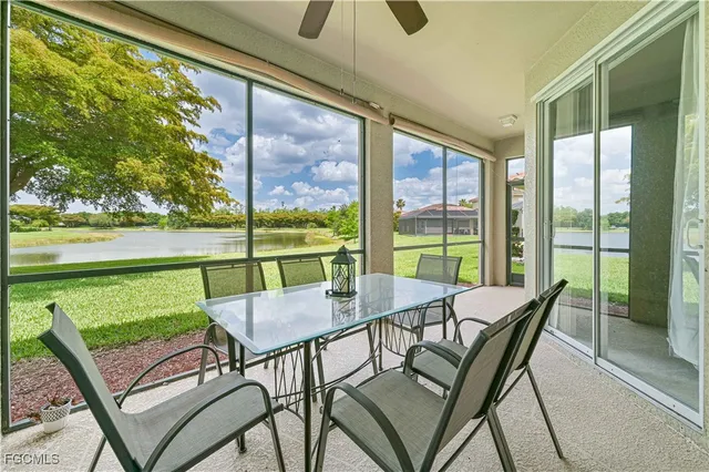 a view of a porch with furniture and a yard