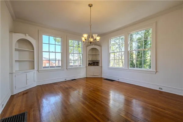 a view of a room window and wooden floor