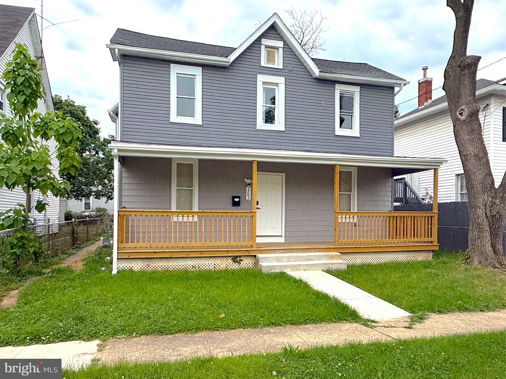 Charming gray home with inviting porch.