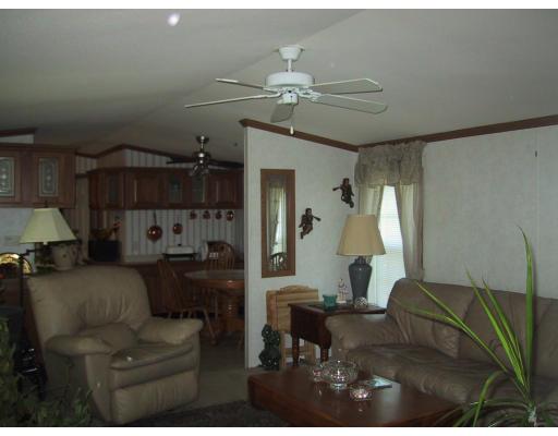 3 Willow Road Newton, NH 03858 - Photo 6 of 9 a living room with furniture and a chandelier