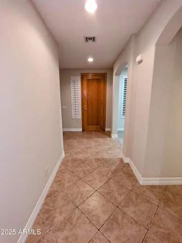 a view of hallway with a window and a ceiling fan