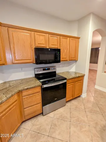 a kitchen with stainless steel appliances a stove a sink and a microwave