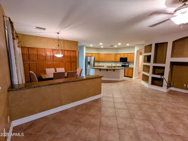 a large kitchen with a large counter top appliances and cabinets