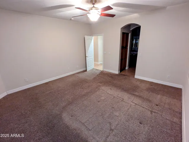 a view of a big room with closet and a chandelier fan